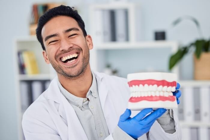 Happy asian man, dentist and teeth for dental care, veneers or healthcare at hospital. Portrait of .