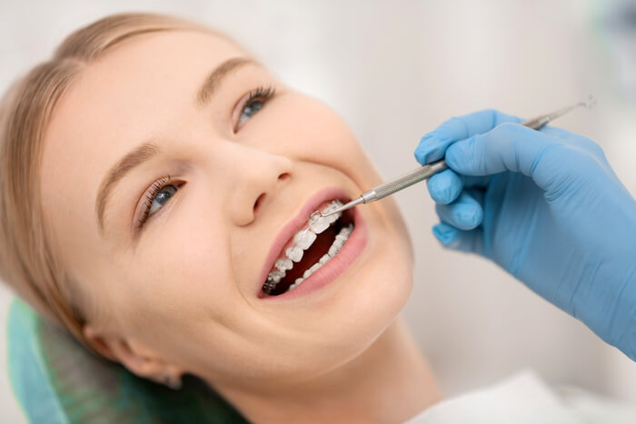 patient-fixing-her-orthodontic-braces-in-dental-cl-2023-11-27-05-28-17-utc